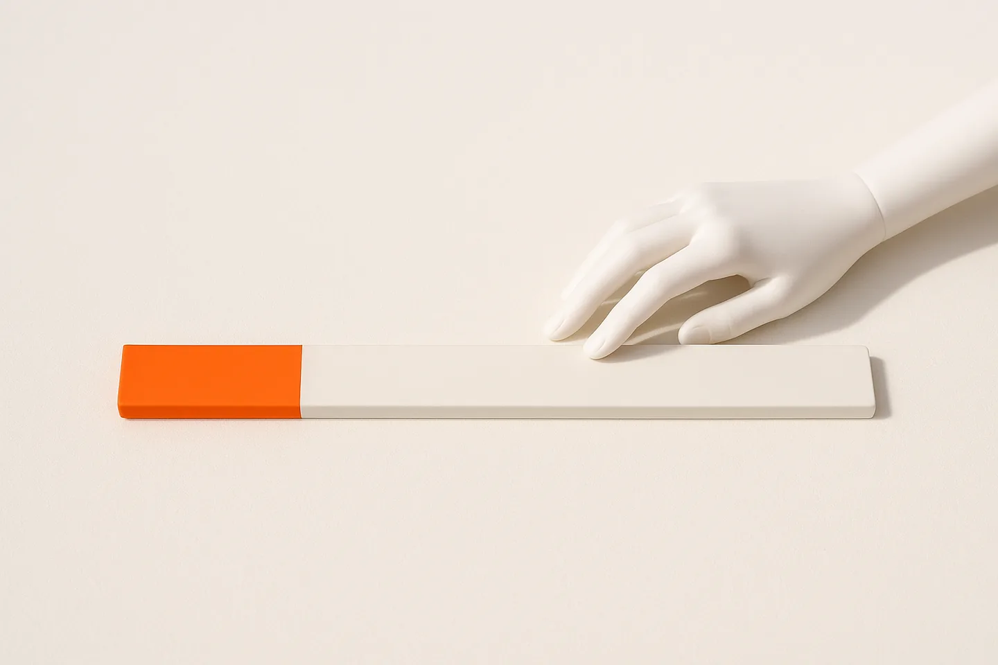 A long orange ruler on white paper with only a short section at its start highlighted, the rest left pale